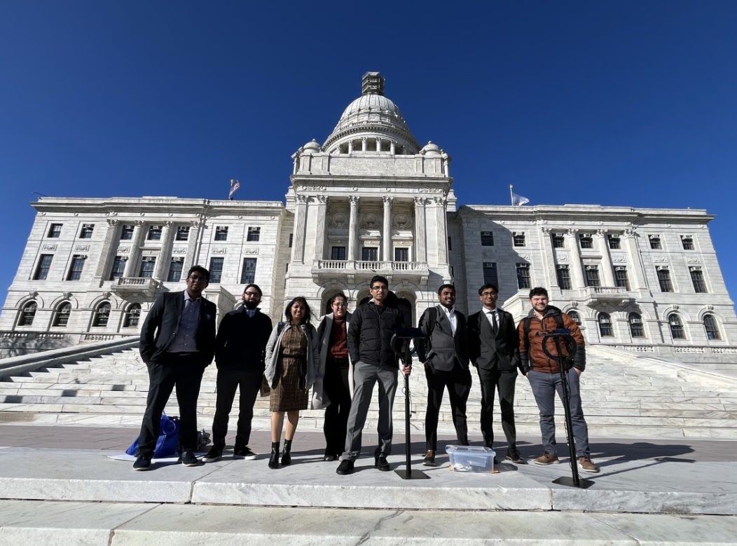 The Wearable Biosensing Lab team on the steps of the Rhode Island State House with demonstration equipment.